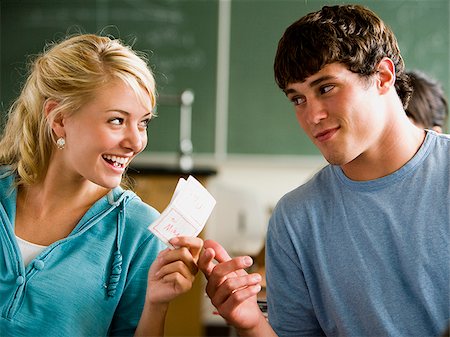 Students passing notes in a classroom. Stock Photo - Premium Royalty-Free, Code: 640-02776590