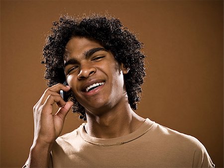 simsearch:640-02776875,k - young man in a brown shirt on a cell phone. Stock Photo - Premium Royalty-Free, Code: 640-02776865