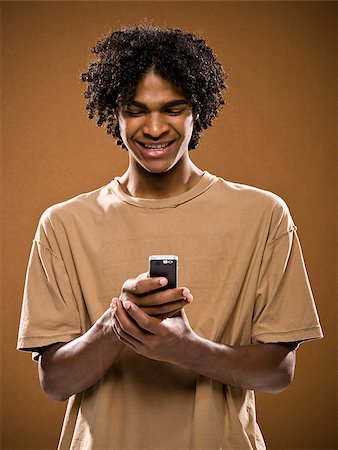 simsearch:640-02776875,k - young man in a brown shirt on a cell phone. Stock Photo - Premium Royalty-Free, Code: 640-02776866