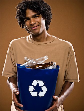 simsearch:640-02776875,k - young man in a brown shirt holding a recycling bin. Stock Photo - Premium Royalty-Free, Code: 640-02776867
