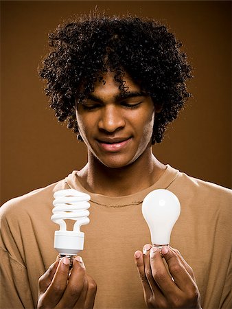 simsearch:640-02776875,k - young man in a brown shirt holding light bulbs. Stock Photo - Premium Royalty-Free, Code: 640-02776877