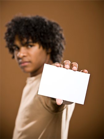 simsearch:640-02776875,k - young man in a brown shirt holding a note card. Stock Photo - Premium Royalty-Free, Code: 640-02776872