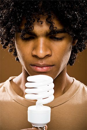 simsearch:640-02776875,k - young man in a brown shirt holding light bulbs. Stock Photo - Premium Royalty-Free, Code: 640-02776884