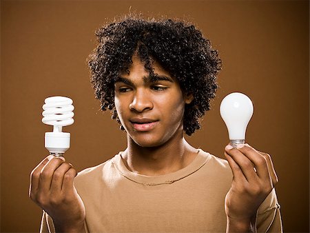 simsearch:640-02776875,k - young man in a brown shirt holding light bulbs. Stock Photo - Premium Royalty-Free, Code: 640-02776881
