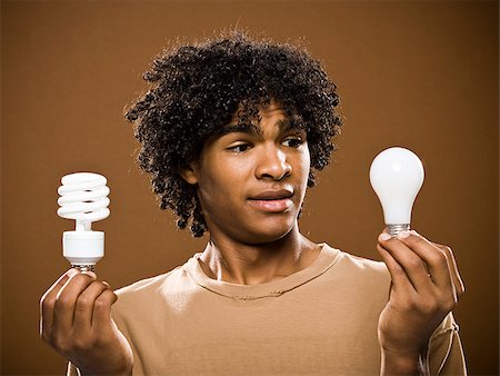 simsearch:640-02776875,k - young man in a brown shirt holding light bulbs. Stock Photo - Premium Royalty-Free, Code: 640-02776882