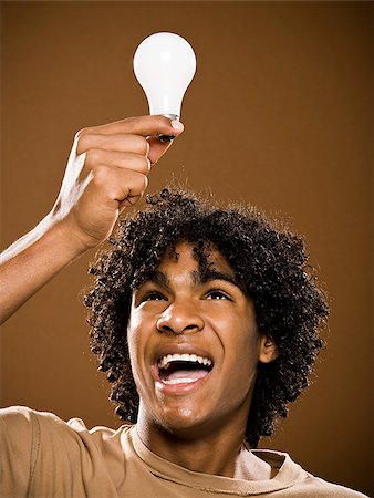 simsearch:640-02776875,k - young man in a brown shirt holding light bulbs. Stock Photo - Premium Royalty-Free, Code: 640-02776883