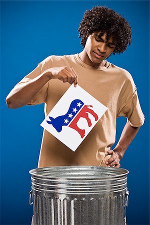 simsearch:640-02776875,k - young man in a brown shirt throwing away a political party symbol. Stock Photo - Premium Royalty-Free, Code: 640-02776898
