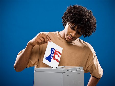 simsearch:640-02776875,k - young man in a brown shirt casting a ballot. Stock Photo - Premium Royalty-Free, Code: 640-02776904