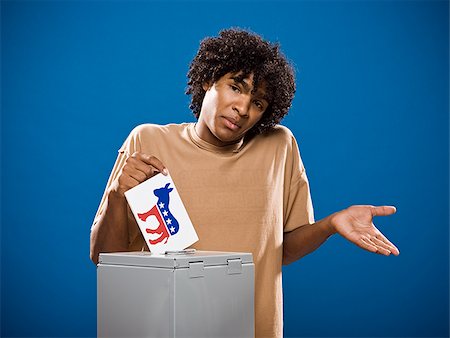 simsearch:640-02776875,k - young man in a brown shirt casting a ballot. Stock Photo - Premium Royalty-Free, Code: 640-02776905