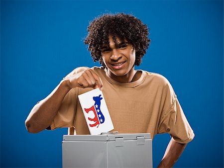 simsearch:640-02776875,k - young man in a brown shirt casting a ballot. Stock Photo - Premium Royalty-Free, Code: 640-02776906