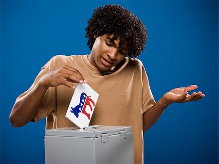 simsearch:640-02776875,k - young man in a brown shirt casting a ballot. Stock Photo - Premium Royalty-Free, Code: 640-02776908