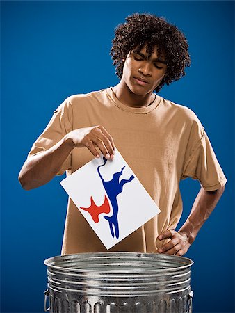 simsearch:640-02776875,k - young man in a brown shirt throwing away a political party symbol. Stock Photo - Premium Royalty-Free, Code: 640-02776900