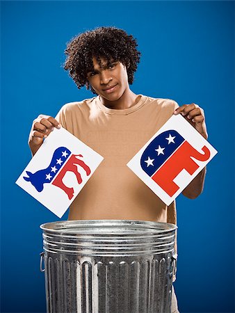 simsearch:640-02776875,k - young man in a brown shirt throwing away a political party symbol. Stock Photo - Premium Royalty-Free, Code: 640-02776902