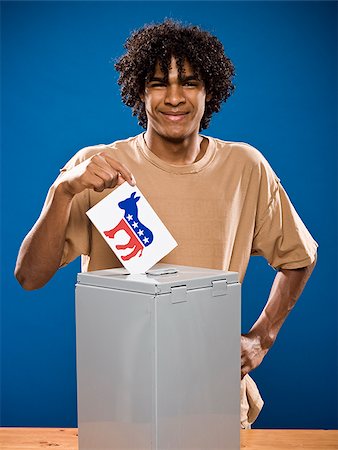simsearch:640-02776875,k - young man in a brown shirt casting a ballot. Stock Photo - Premium Royalty-Free, Code: 640-02776914