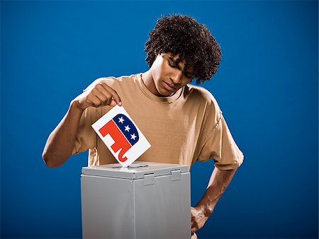 simsearch:640-02776875,k - young man in a brown shirt casting a ballot. Stock Photo - Premium Royalty-Free, Code: 640-02776910