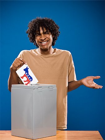 simsearch:640-02776875,k - young man in a brown shirt casting a ballot. Stock Photo - Premium Royalty-Free, Code: 640-02776912