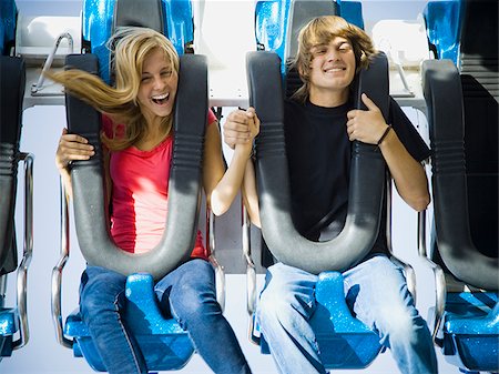 rollercoaster teenagers - young couple at an amusement park Stock Photo - Premium Royalty-Free, Code: 640-02777753