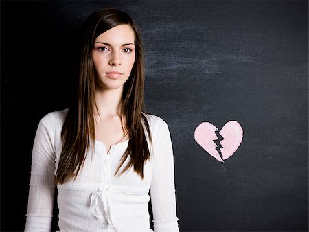 young woman against a chalkboard Stock Photo - Premium Royalty-Free, Code: 640-02778328