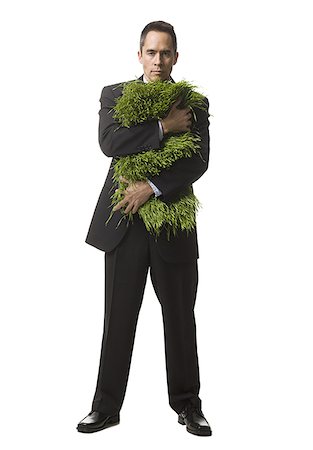 businessperson holding a patch of grass Stock Photo - Premium Royalty-Free, Code: 640-02778414