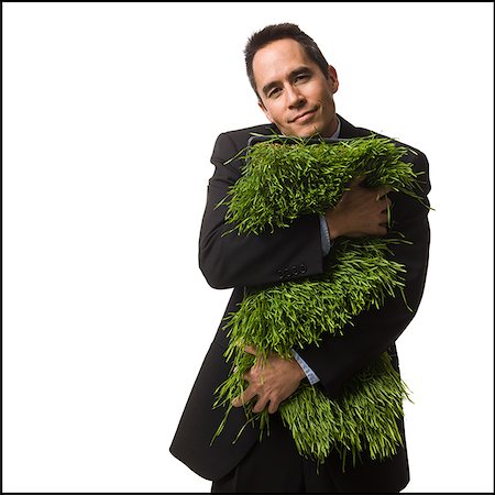 businessperson holding a patch of grass Stock Photo - Premium Royalty-Free, Code: 640-02778415