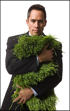 businessperson holding a patch of grass Stock Photo - Premium Royalty-Free, Code: 640-02778416