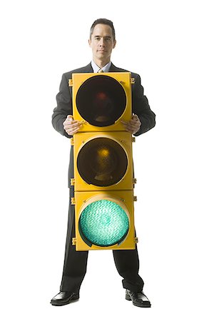 businessperson holding a traffic signal Stock Photo - Premium Royalty-Free, Code: 640-02778445
