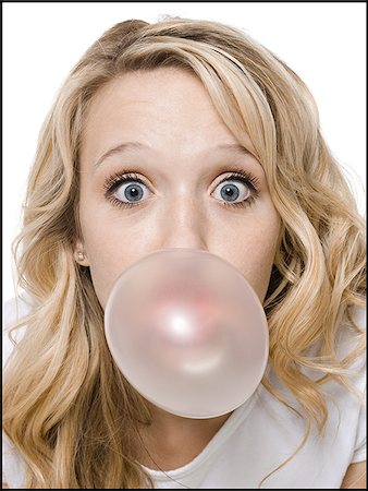 young woman chewing bubble gum Stock Photo - Premium Royalty-Free, Code: 640-02778460