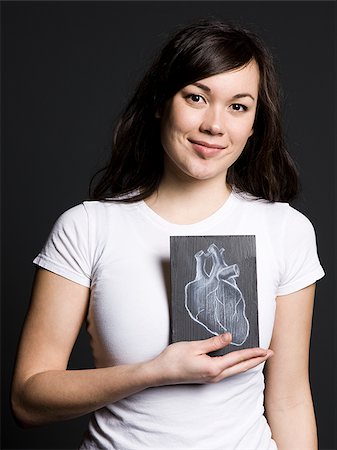 Woman with a drawing of a heart Stock Photo - Premium Royalty-Free, Code: 640-02778824