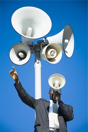 Man yelling through bullhorn Stock Photo - Premium Royalty-Free, Code: 640-02770049