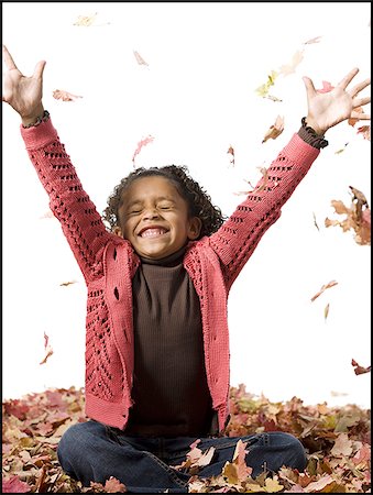 pile leaves playing - Young girl playing in fallen leaves Stock Photo - Premium Royalty-Free, Code: 640-02770512