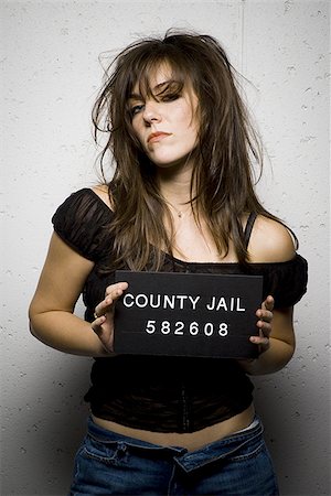 people with a jail sign - Mug shot of woman with messy hair Stock Photo - Premium Royalty-Free, Code: 640-02770796