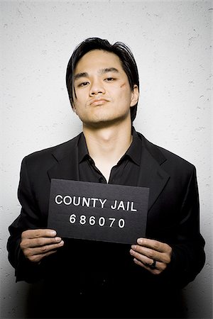 people with a jail sign - Mug shot of man with cut Stock Photo - Premium Royalty-Free, Code: 640-02771015