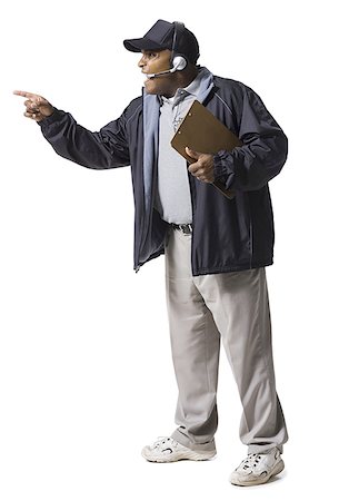 Coach with clipboard and headset pointing Stock Photo - Premium Royalty-Free, Code: 640-02771148
