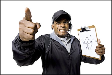 Male head coach pointing finger with headset Stock Photo - Premium Royalty-Free, Code: 640-02771195