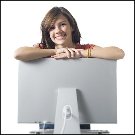 simsearch:640-02773530,k - Girl leaning on computer monitor smiling Stock Photo - Premium Royalty-Free, Code: 640-02771313