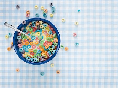 Bowl of cereal with milk and cereal on tablecloth Stock Photo - Premium Royalty-Free, Code: 640-02771600