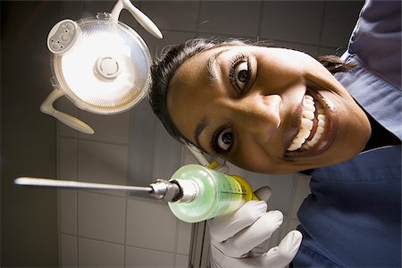 dramatic portrait - Dental hygienist with syringe dramatic angle Stock Photo - Premium Royalty-Free, Code: 640-02771705