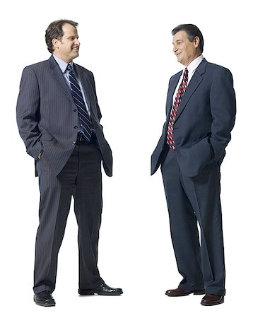 executive standing white background - Two businessmen talking and smiling Stock Photo - Premium Royalty-Free, Code: 640-02771846