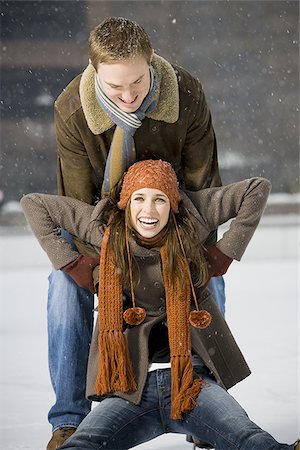 Couple falling while ice skating Stock Photo - Premium Royalty-Free, Code: 640-02772461