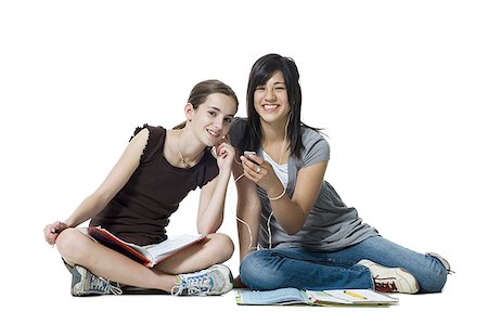 simsearch:640-03265333,k - Two girls sitting cross legged with homework and mp3 player Stock Photo - Premium Royalty-Free, Code: 640-02773306