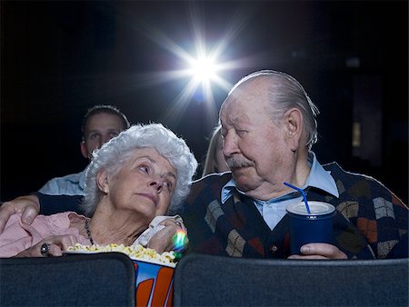 simsearch:640-02773406,k - Man and woman watching movie in theater crying with popcorn Stock Photo - Premium Royalty-Free, Code: 640-02773358