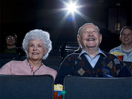 simsearch:640-02773406,k - Man and woman watching film at movie theater smiling Stock Photo - Premium Royalty-Free, Code: 640-02773352