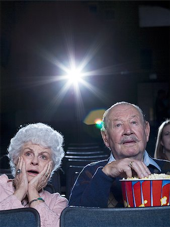 simsearch:640-02773406,k - Man and woman watching film at movie theatre frightened Stock Photo - Premium Royalty-Free, Code: 640-02773364