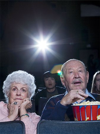 simsearch:640-02773406,k - Man and woman watching film at movie theatre frightened Stock Photo - Premium Royalty-Free, Code: 640-02773365