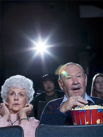 simsearch:640-02773406,k - Man and woman watching film at movie theatre frightened Stock Photo - Premium Royalty-Free, Code: 640-02773366
