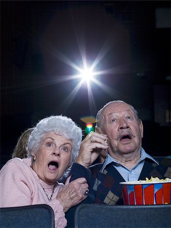 simsearch:640-02773406,k - Man and woman watching film at movie theatre frightened Stock Photo - Premium Royalty-Free, Code: 640-02773368