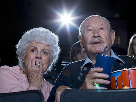 Man and woman watching film at movie theatre frightened Stock Photo - Premium Royalty-Free, Code: 640-02773363