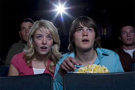 simsearch:640-02773406,k - Boy and girl with popcorn frightened at movie theater Stock Photo - Premium Royalty-Free, Code: 640-02773381