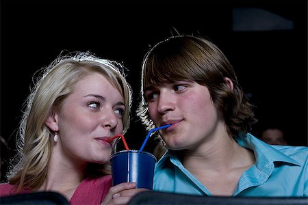 simsearch:640-02773406,k - Boy and girl sharing beverage at movie theater Stock Photo - Premium Royalty-Free, Code: 640-02773405