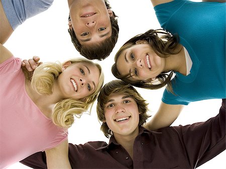 Low level view of four people smiling Stock Photo - Premium Royalty-Free, Code: 640-02773485